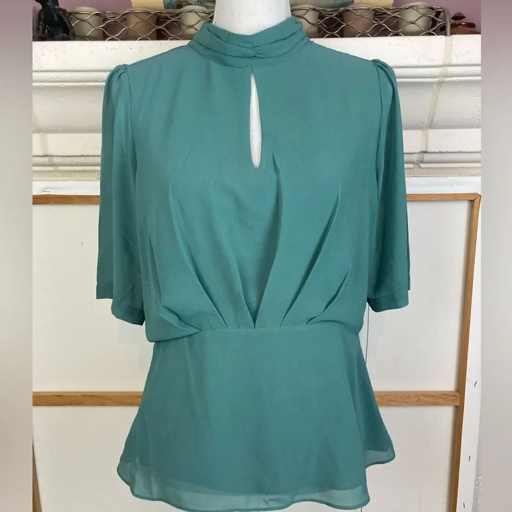 Naked Zebra sculptured Blouse w/ waist nip peplum & keyhole neckline & back